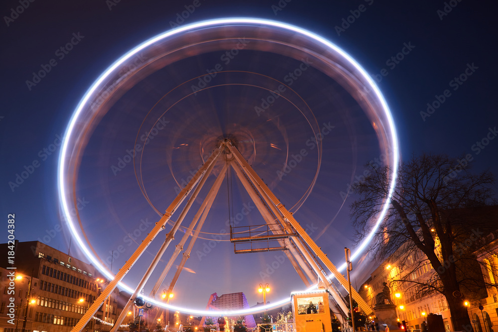 Construction and wagons of the  Ferris wheel at night  in Poznan.