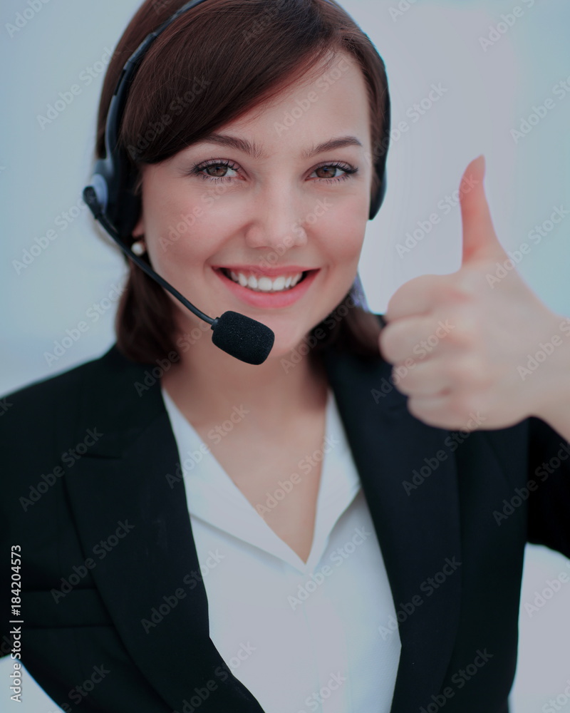 Beautiful woman working at callcenter, using headset showing thu Beautiful woman working at callcenter, using headset showing thu