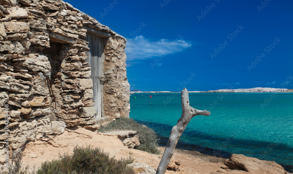 Formentera Ibiza. An old fishing garage on a crystal beach