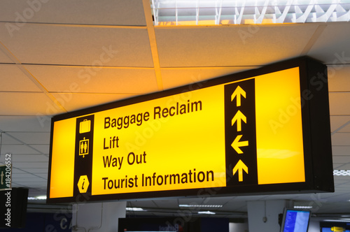 Airport sign giving directions to baggage reclaim, lift, way out and tourist information