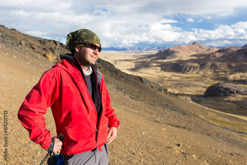 Tourist man adventurer backpacker standing mountain peak, Peru.