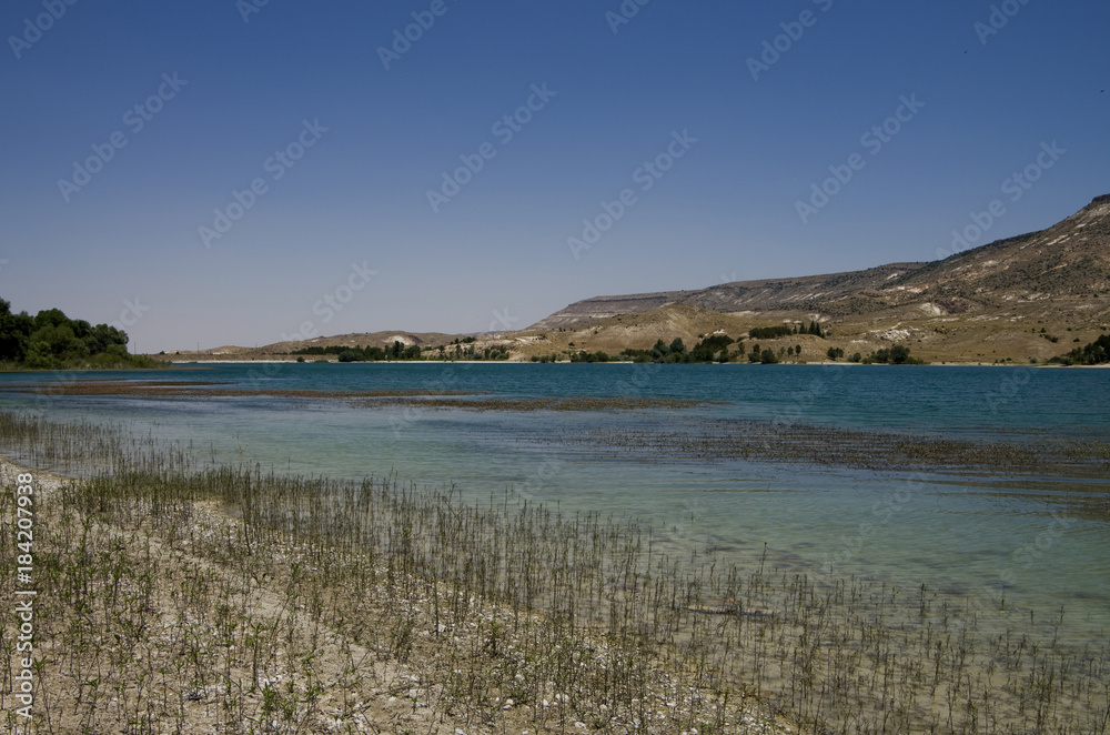 Lake with light blue water in the South Cappadocia Valley.