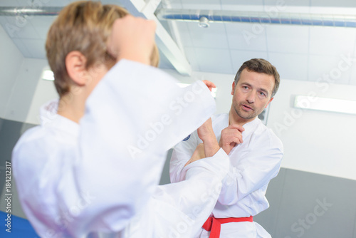 Martial arts master instructing student