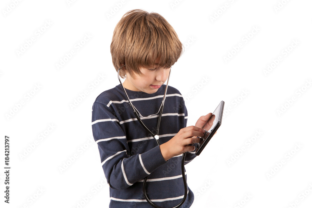Young geek boy inspecting his tablet device with a stethoscope