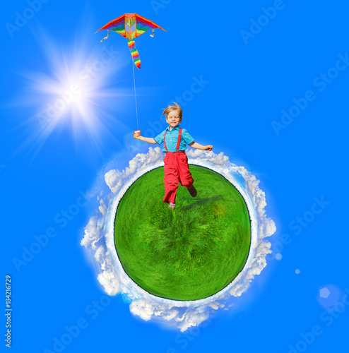 A child with a kite in his hands is on the Earth, on green grass. Around the sun, sky and clouds. Fantasy on the theme of family, childhood, future and happiness.