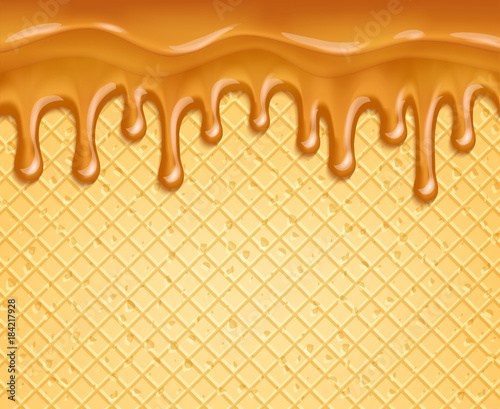 Caramel or honey flowing over waffle background