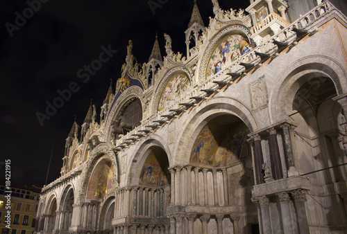 Facade view of Saint Mark's Basilica (San Marco) at night in Venice / Italy. Iconic cathedral with a cavernous gilded interior, myriad mosaics & an on-site museum. © theendup
