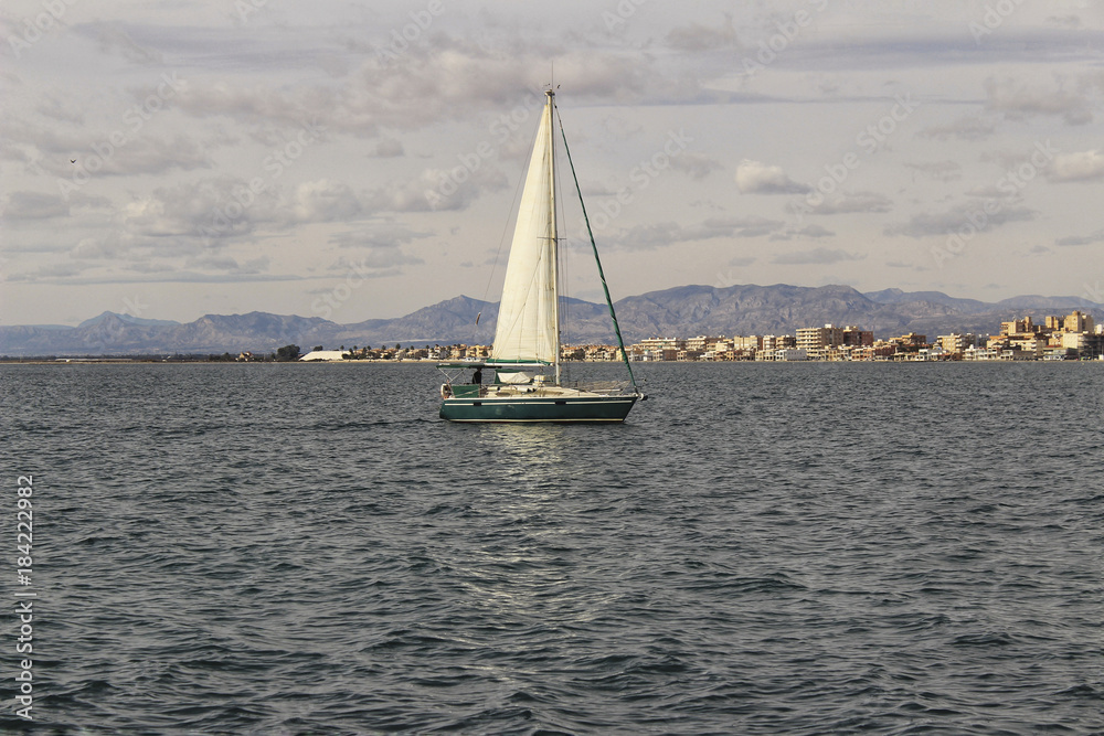 Fototapeta premium Sailboat entering the port