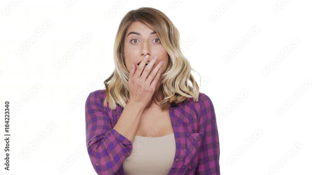 portrait of young woman 30s with brown eyes being scared hearing bad news covering mouth with hands in fear over white background in studio. Concept of emotions portrait of young woman 30s with brown eyes being scared hearing bad news covering mouth with hands in fear over white background in studio. Concept of emotions