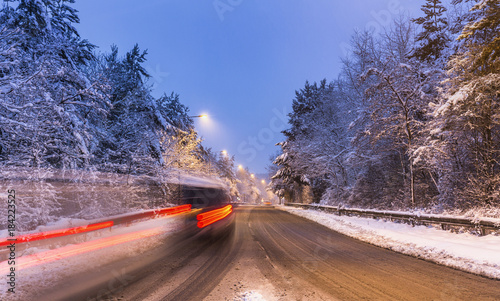 Long Trails of Car Lights on Road Covered in Snow at Evening © Eddie Cloud