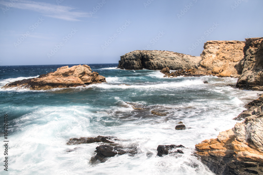 The coastline with rocks on Antiparos, one of the Cyclade islands in Greece
