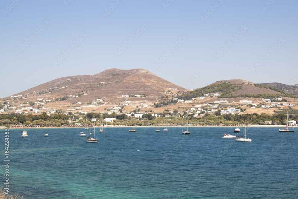 View over a bay with a typical village on Paros, one of the Cyclade islands in Greece
