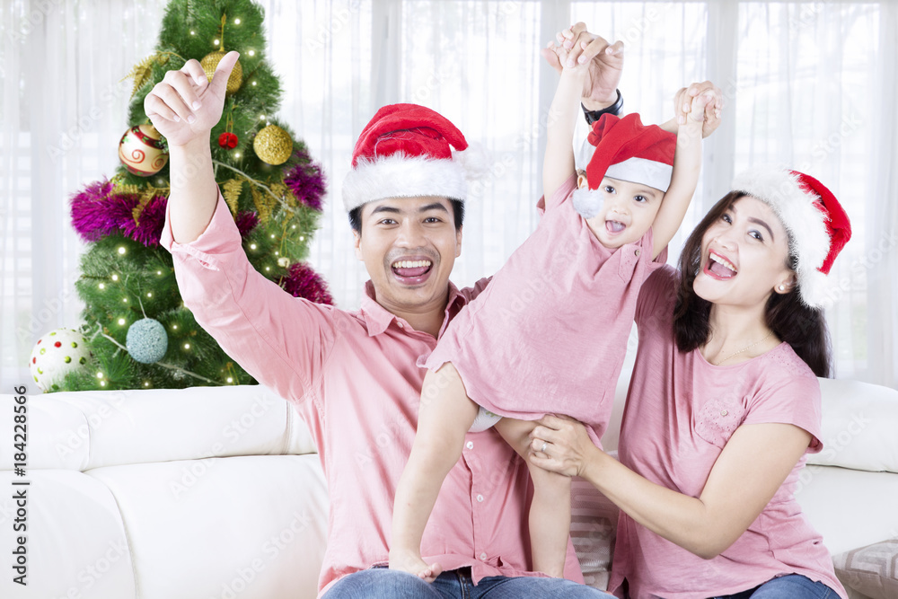 Fototapeta premium Cheerful family celebrating Christmas at home