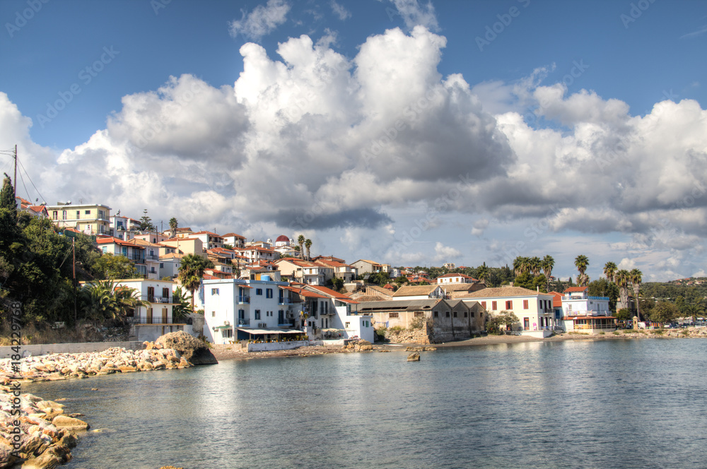 View over the bay with crystal clear water and typical houses in Koroni, Messinia, Greece
