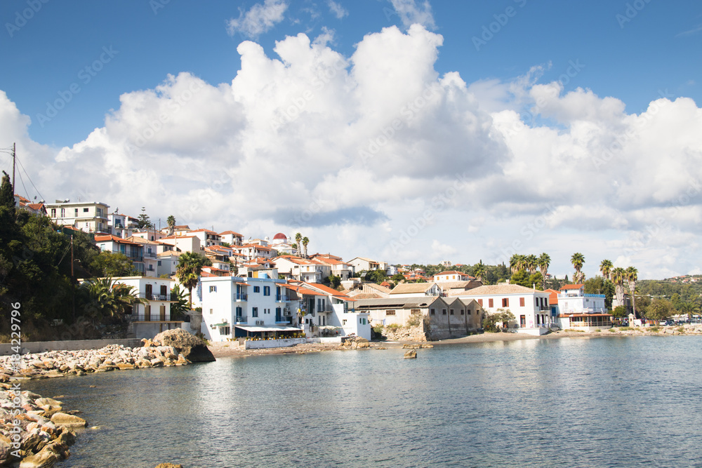 View over the bay with crystal clear water and typical houses in Koroni, Messinia, Greece
