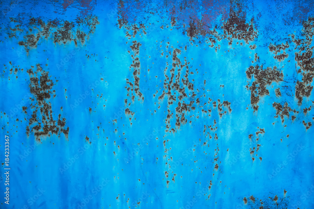 old blue painted wall with rusty spots grunge texture