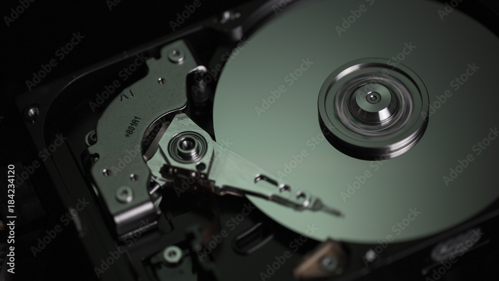 Disassembled hard drive from the computer, hdd with mirror effect Opened hard drive from the computer hdd with mirror effects Part of computer pc.