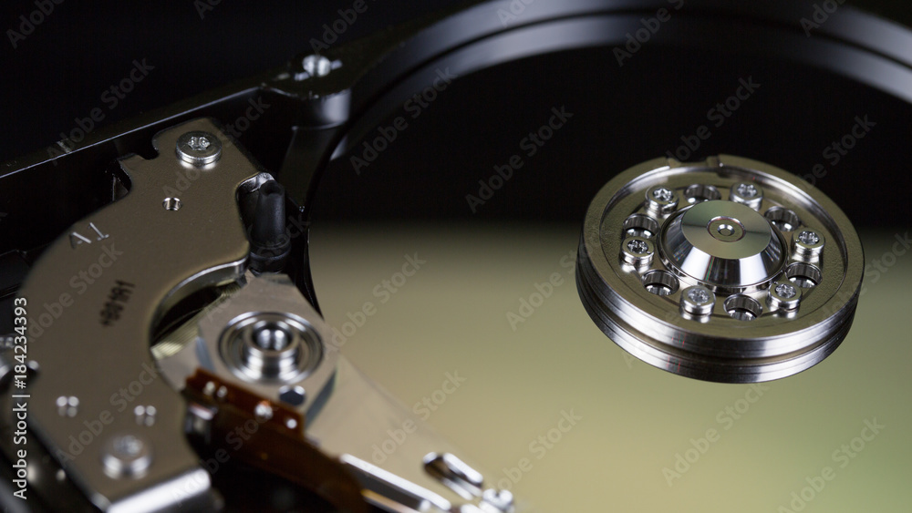 Disassembled hard drive from the computer, hdd with mirror effect Opened hard drive from the computer hdd with mirror effects Part of computer pc. Disassembled hard drive from the computer, hdd with mirror effect Opened hard drive from the computer hdd with mirror effects Part of computer pc.
