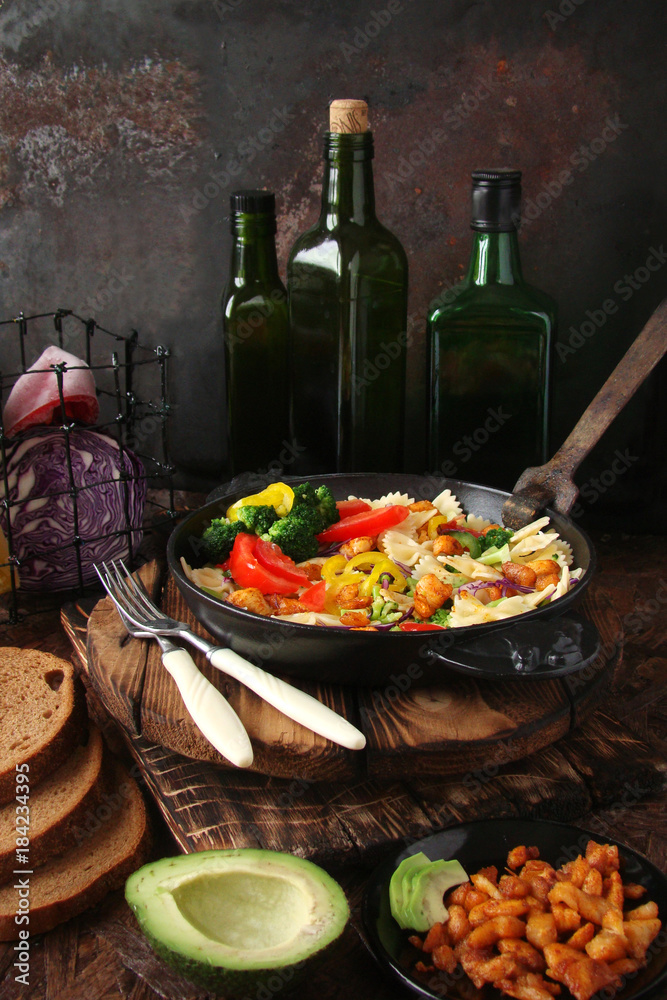 Farfalle pasta with slices of grilled chicken, sweet peppers, avocado, cabbage, broccoli, tomatoes and red cabbage Farfalle pasta with slices of grilled chicken, sweet peppers, avocado, cabbage, broccoli, tomatoes and red cabbage