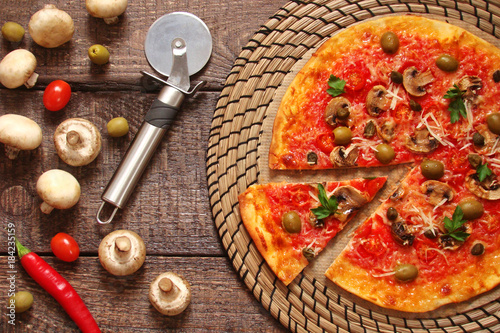 Pizza with tomatoes, mushrooms, black olives, Parmesan cheese, capers