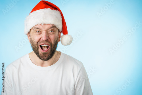 Surpriced man in santa claus hat