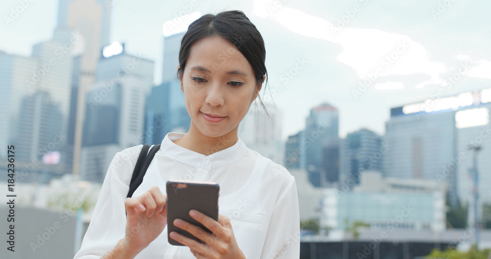 Business woman use of smart phone in city Business woman use of smart phone in city