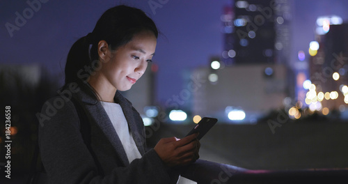 Asian woman use of mobile phone at night