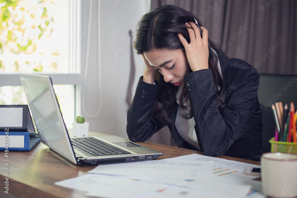 Desperate businesswoman worried in office Desperate businesswoman worried in office