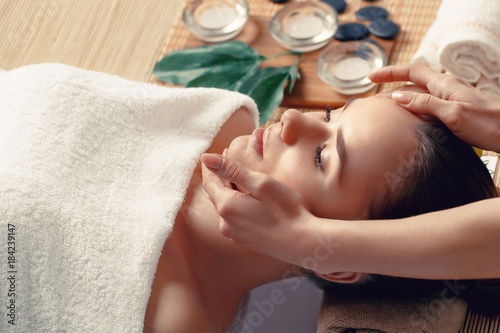 Portrait of young Beautiful woman having relaxing in spa massage salon. Leisure. Spa. Massage procedure. Healthy lifestyle and relaxation concept