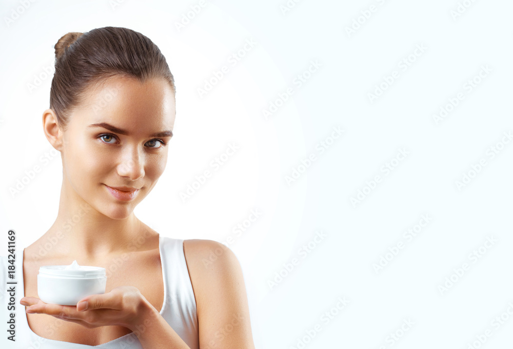 portrait of beautiful woman applying some cream to her face for skin care portrait of beautiful woman applying some cream to her face for skin care