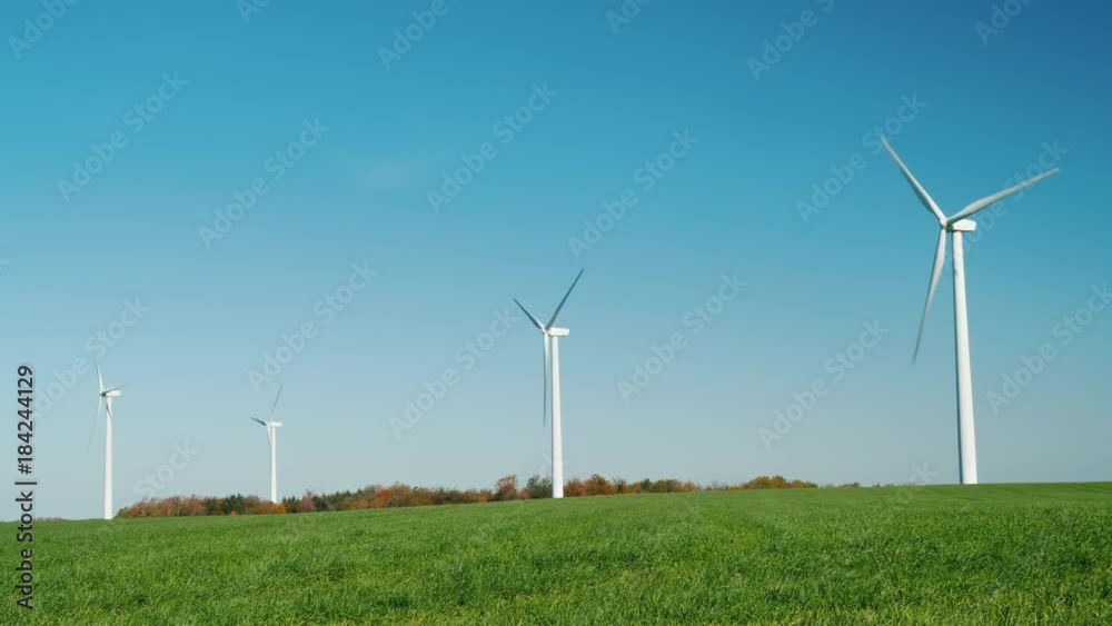 Several wind turbines on a green hill Several wind turbines on a green hill