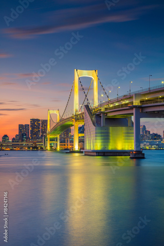 Fototapeta Naklejka Na Ścianę i Meble -  Rainbow Bridge, Tokyo. Cityscape image of Tokyo, Japan with Rainbow Bridge during sunset.