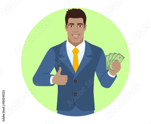 Businessman with cash money and showing thumb up