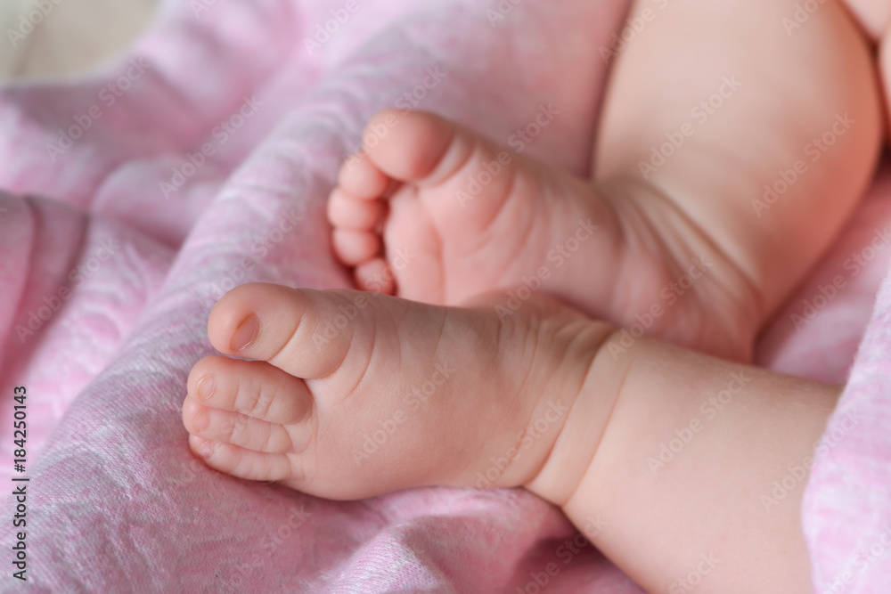 Close-up beautiful sleeping newborn on a pink, soft blanket.Closeup photo.