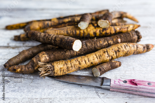 Scorzonera, black salcifia on a wooden background. 