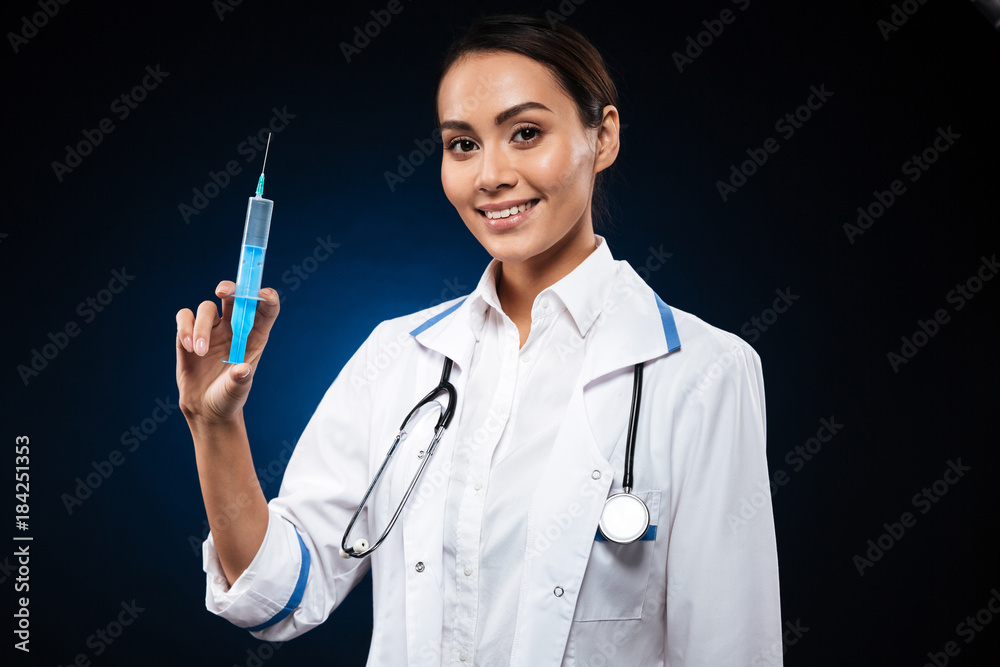 Smiling lady holding syringe and looking camera isolated Smiling lady holding syringe and looking camera isolated