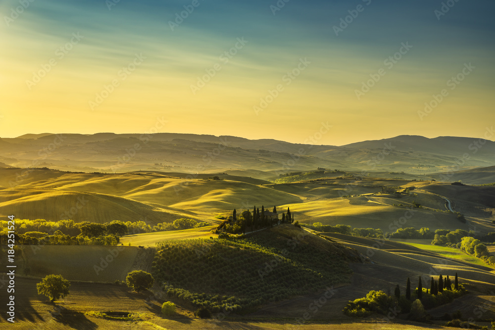 Tuscany countryside panorama, rolling hills and fields at sunrise. Italy