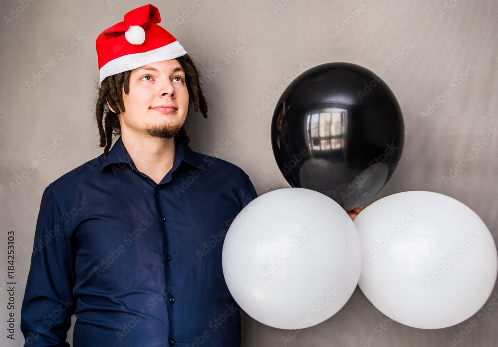 yong european man with balloons in santa hat yong european man with balloons in santa hat