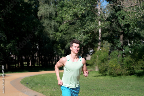 Man run in park on sunny summer day
