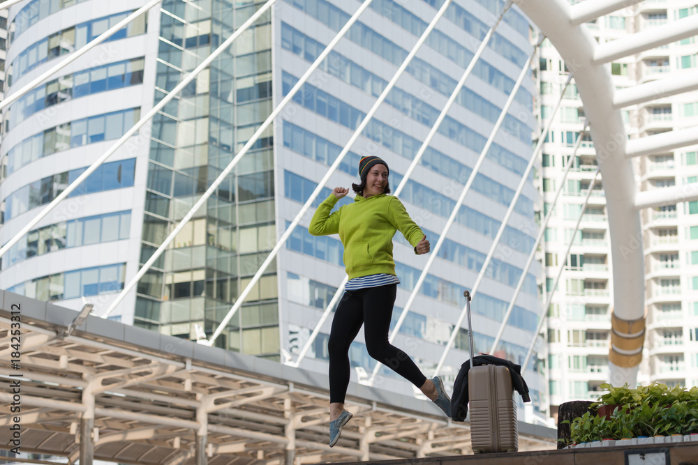 Excited Russian beautiful woman jump raising her arms with luggage travel journey ideas concept. Happy glad woman tourist, vacation holidays, winter traveler Excited Russian beautiful woman jump raising her arms with luggage travel journey ideas concept. Happy glad woman tourist, vacation holidays, winter traveler