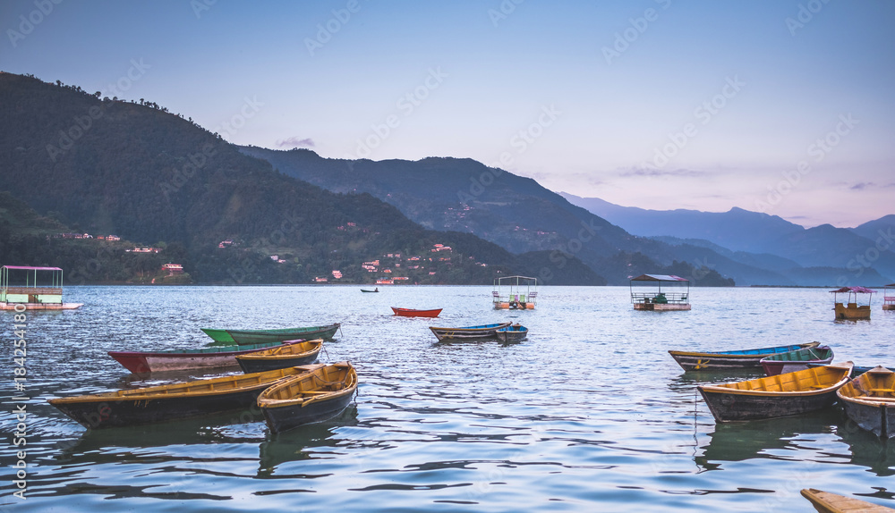 Colourful boats on the water of Phewa lake, Nepal