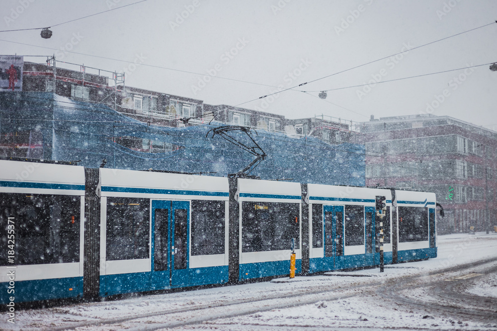 Tram in Amsterdam on snowy day