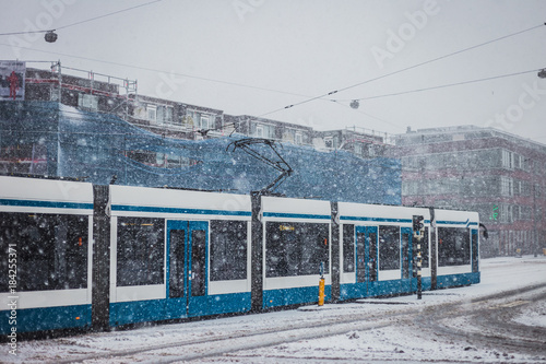 Tram in Amsterdam on snowy day