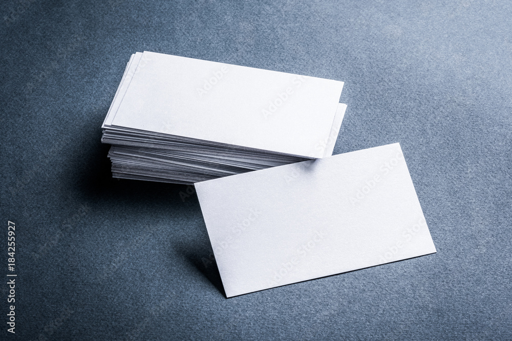 Two stacks of blank paper business cards on textured background. Two stacks of blank paper business cards on textured background.
