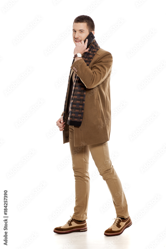 young handsome man in winter clothes with a scarf young handsome man in winter clothes with a scarf