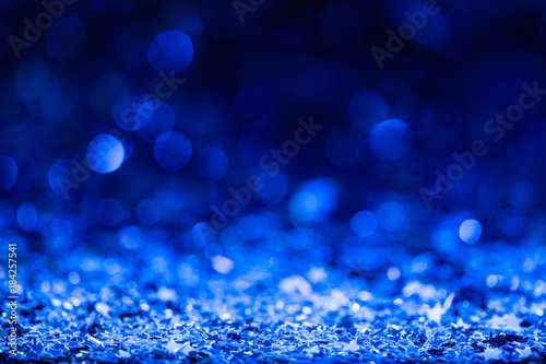 christmas background with blue blurred shiny confetti stars