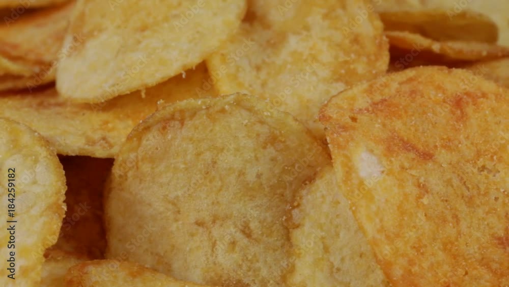 Rotating potato chips close up, macro view food background