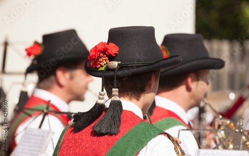 Young musician in typical costume during an autumn local celebration in Val di Funes ( South Tyrol )