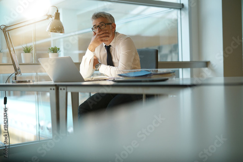 Konstfotografi Businessman working on laptop in office, being concerned
