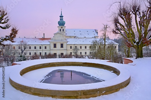 Snowy Winter Garden with Fountain in the Prague Benedictine Monastery photo